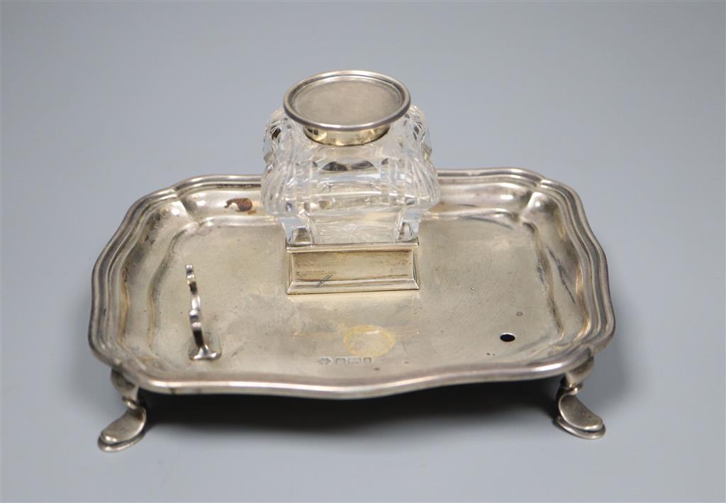 An Edwardian silver inkstand with mounted glass well and pen rest (one rest missing), William Hutton & Sons,